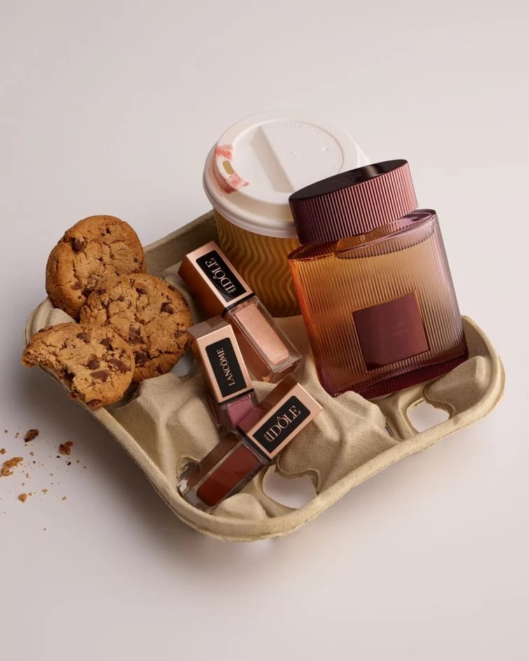 Coffee, cookies, and brown accessories arranged on a warm neutral tray