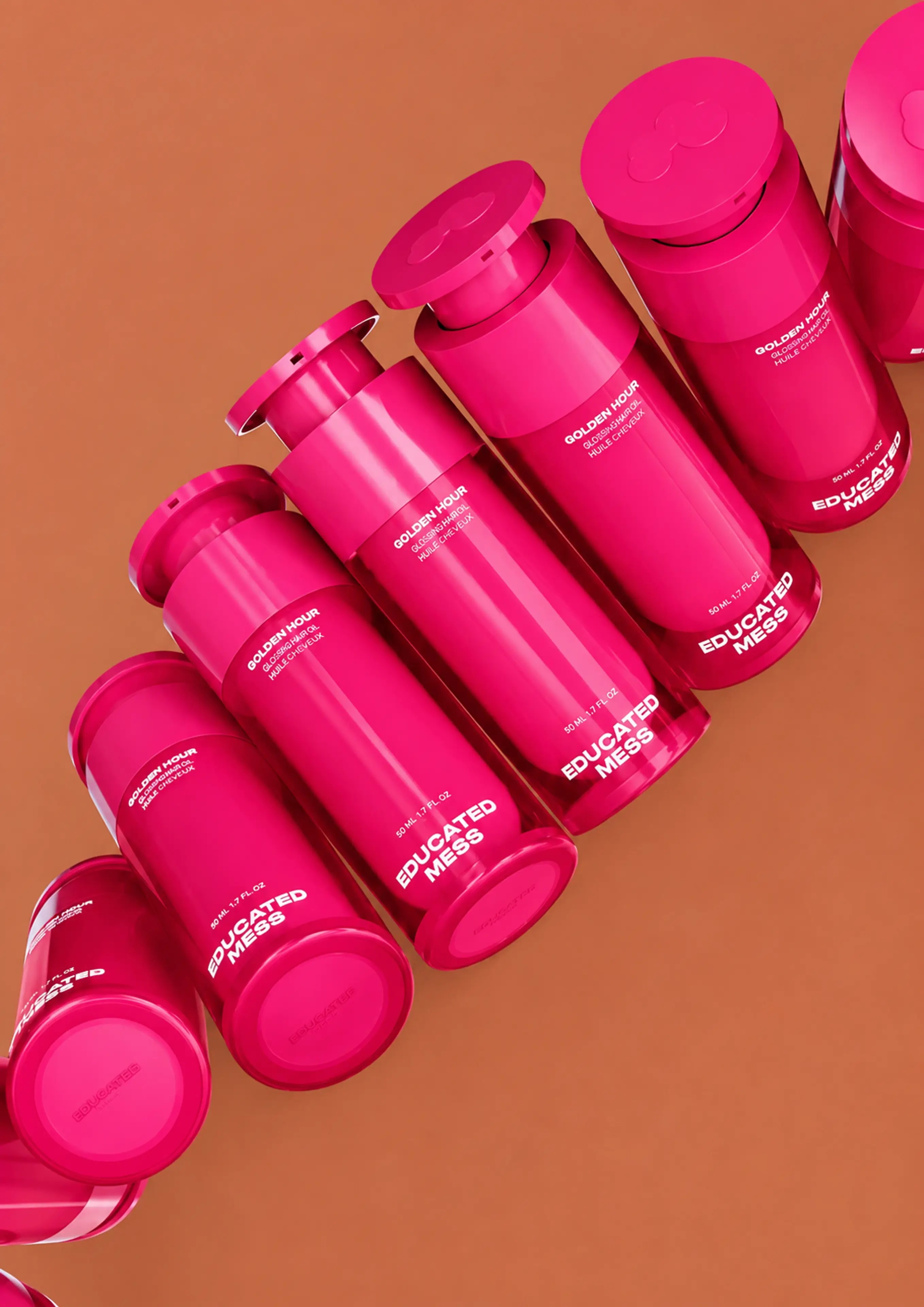 A sculptural arrangement of bright pink bottles on terracotta