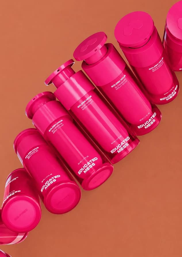 A sculptural arrangement of bright pink bottles on terracotta