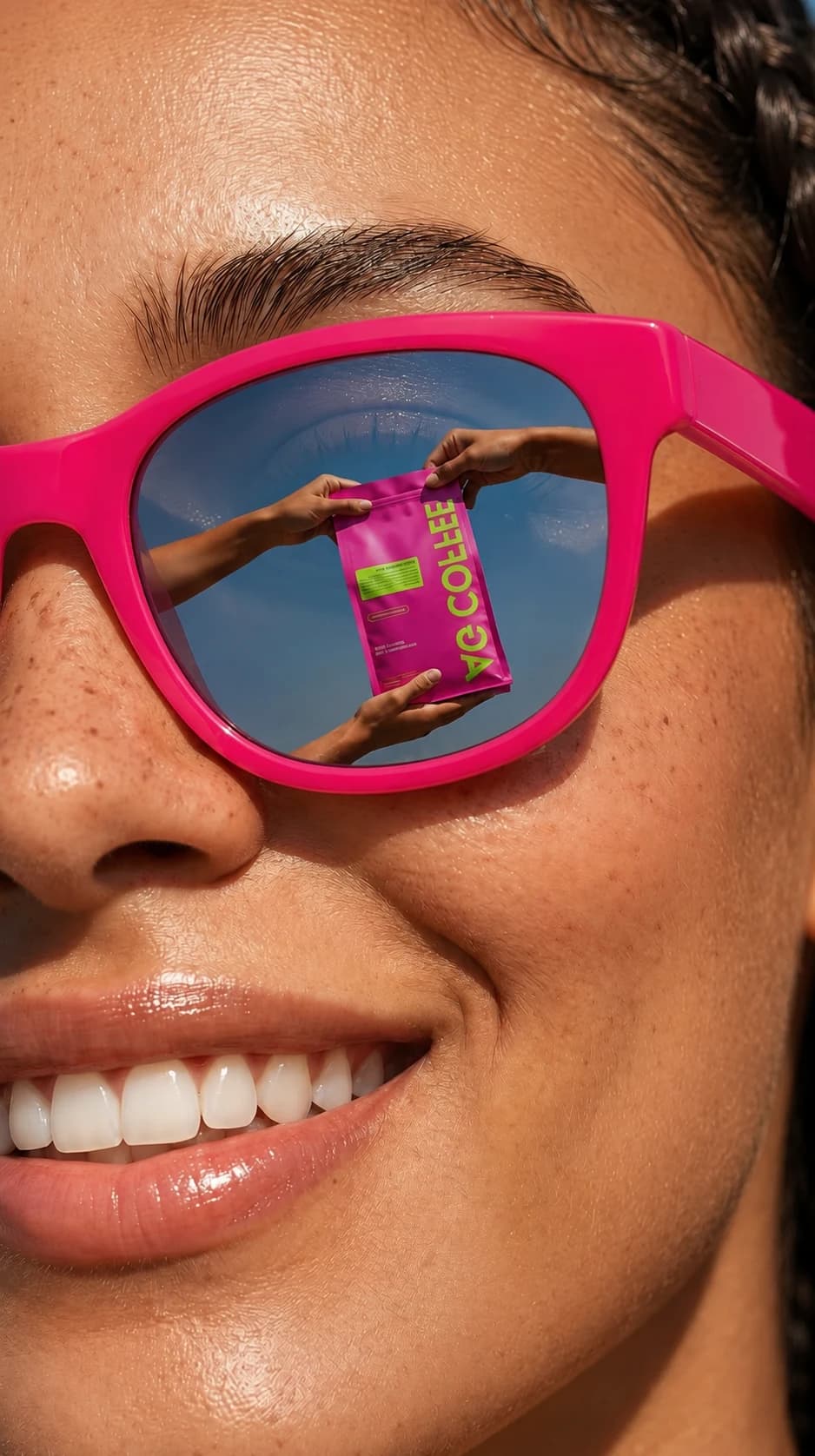 A smiling woman wearing vivid pink sunglasses